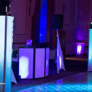 A dj set up in a room with blue lights.