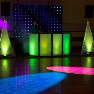 A dj set up with colorful lights and speakers.