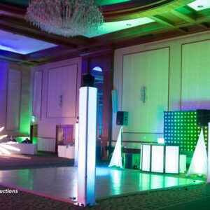 A large ballroom with a stage and lights.