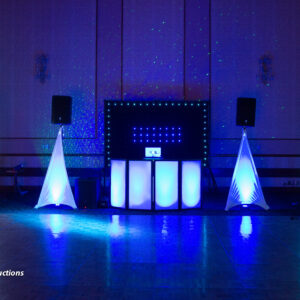 A dj set up in a room with blue lights.