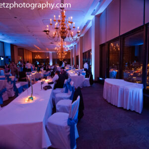 A wedding reception with blue and white tables and chairs.