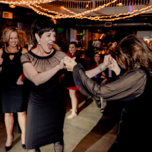 Two women dancing at a party.