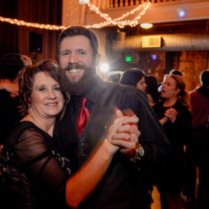 A man and woman dancing at a wedding reception.