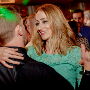 A man and a woman dancing at a party.
