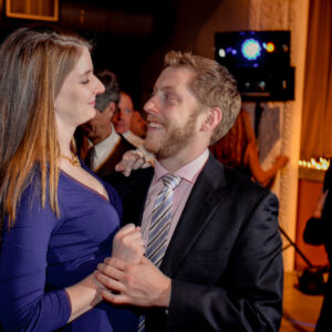 A man and a woman dancing at a party.