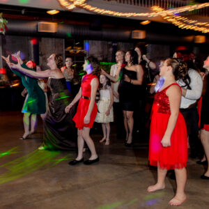 A group of people dancing at a party.