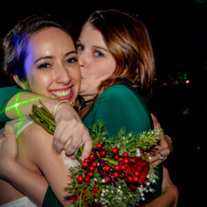 Two women hugging at a wedding.
