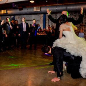 A bride and groom dancing on the floor at a wedding reception.