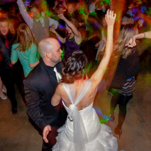 A bride and groom dancing at a wedding reception.