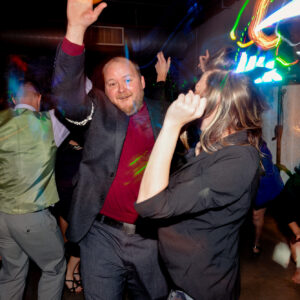 A group of people dancing at a party.