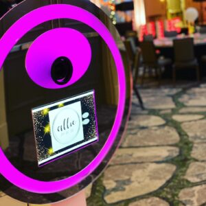 A purple-lit photo booth perfect for taking pictures at a Bat/Bar or Mitvah event.