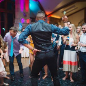 A man dancing on the dance floor at a wedding reception.