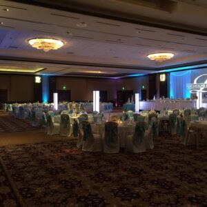A banquet hall set up with blue and white linens.