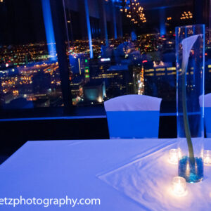 A table with candles and a view of the city.
