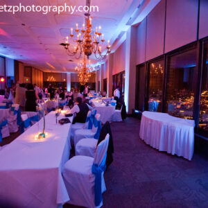 A wedding reception with blue and white tables and chairs.
