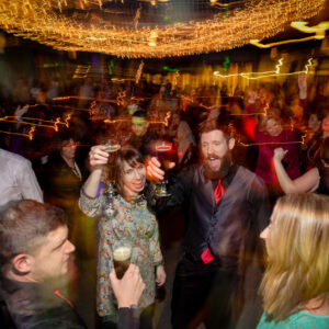 A group of people dancing at a party.