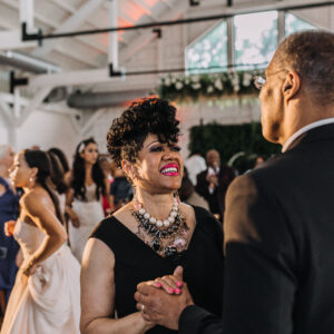 A man and woman dancing at a wedding reception.