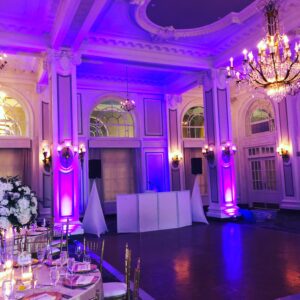 A large ballroom with purple lighting.
