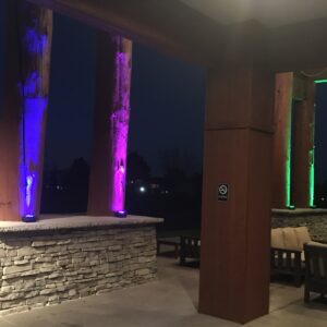 A patio with colorful lighting at night.