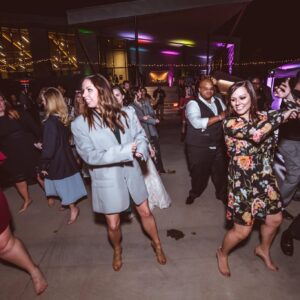 A group of people dancing on the dance floor at a wedding.