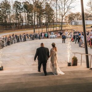A bride and groom walking down the steps at a wedding.