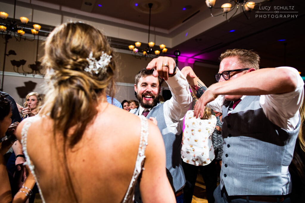 A bride and groom dancing at a wedding reception.