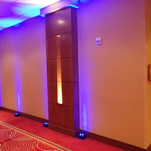 A hallway is lit up with blue and purple lights.