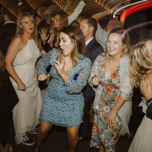 A group of people dancing at a wedding reception.