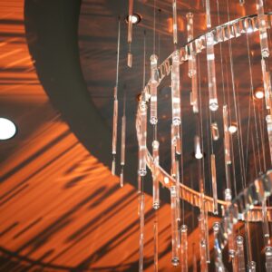A chandelier hanging in a room with orange lights.