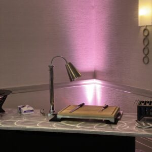 A table with a lamp and purple lighting.
