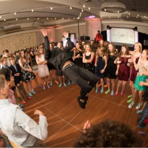 A man jumping in the air in front of a crowd of people.