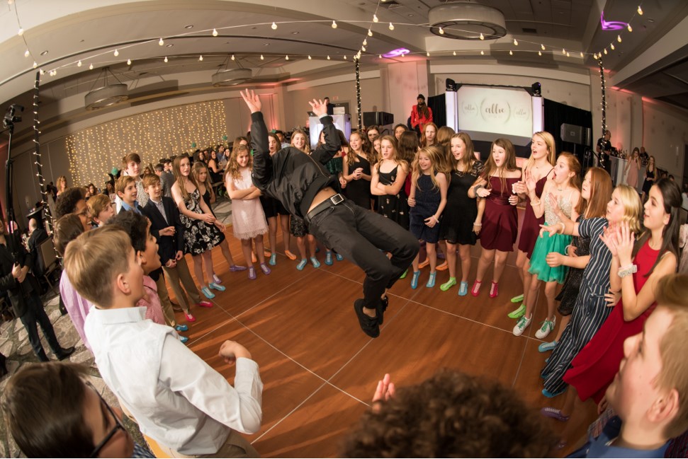 A man jumping in the air in front of a crowd of people.