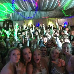 A group of people posing for a photo at a school dance.