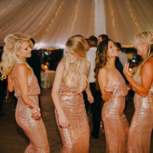 A group of bridesmaids dancing in a tent with a Georgia wedding DJ playing.