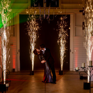 A bride and groom kissing in front of sparklers at their Georgia wedding DJ event.