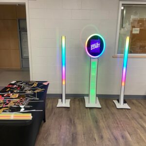 A room adorned for a Georgia wedding, with several colorful lights and a table, awaiting the touch of a DJ service.