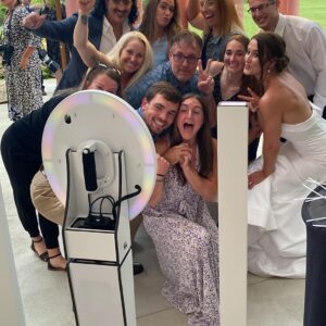 A group of people posing in front of a photo booth rental Georgia.