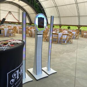 A large tent with tables and chairs in it, and a Georgia corporate DJ setup.
