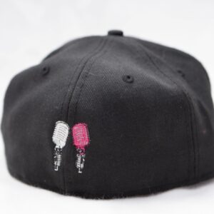 A black hat with two pink ice cream sticks on it, perfect for a photo booth rental in Georgia.