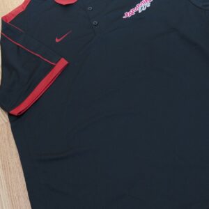 A black and red Nike polo shirt on a wooden floor, ideal for a Georgia corporate DJ service look.