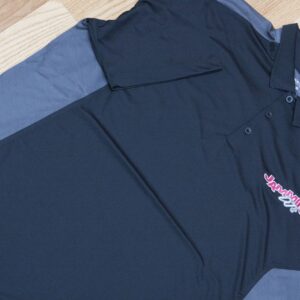 A black and grey polo shirt on a wooden floor, perfect for a Georgia corporate DJ.