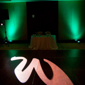 A green lit dance floor with a letter w on it, featuring a top-rated Georgia wedding DJ.