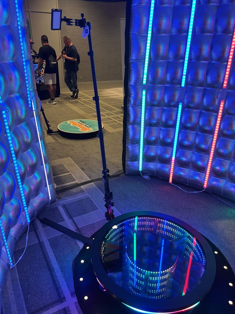 A group of people are standing in a room with lights, enjoying a Georgia corporate DJ service.